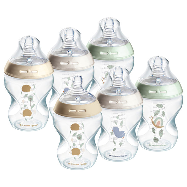 Set of baby bottles with decorative elements on a white background