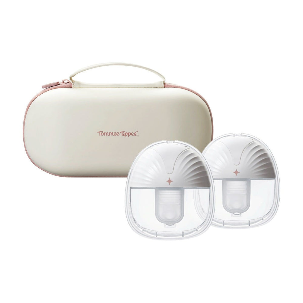 Two front-facing wearable breast pumps in front of a double carry case against a white background.