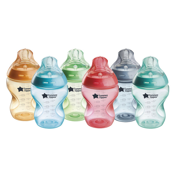 Set of colorful baby bottles with 'Tommee Tippee' branding on a white background