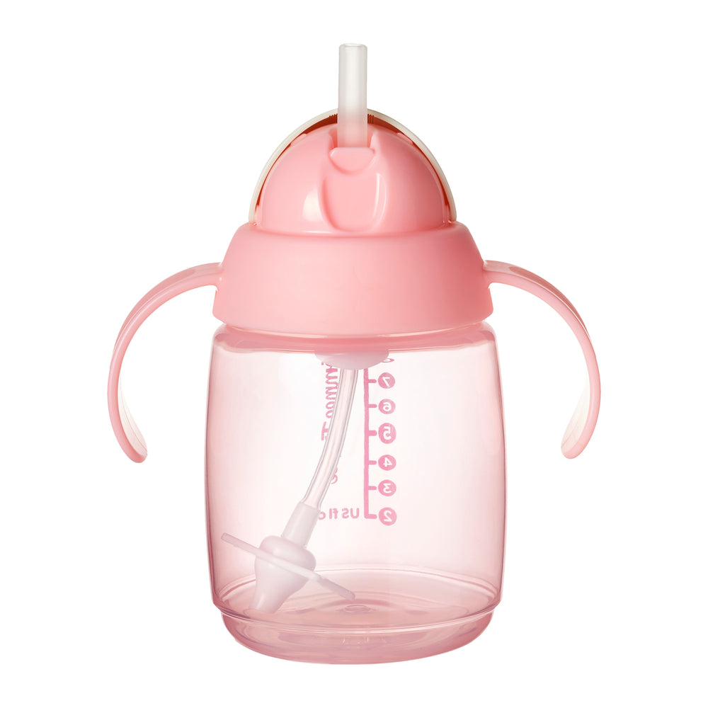 Pink sippy cup with straw on a white background