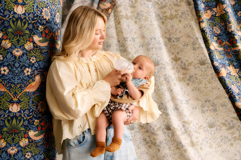 mum feeding baby with fabric surround
