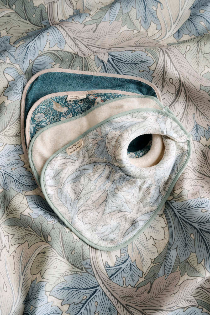 four bibs lying on fabric