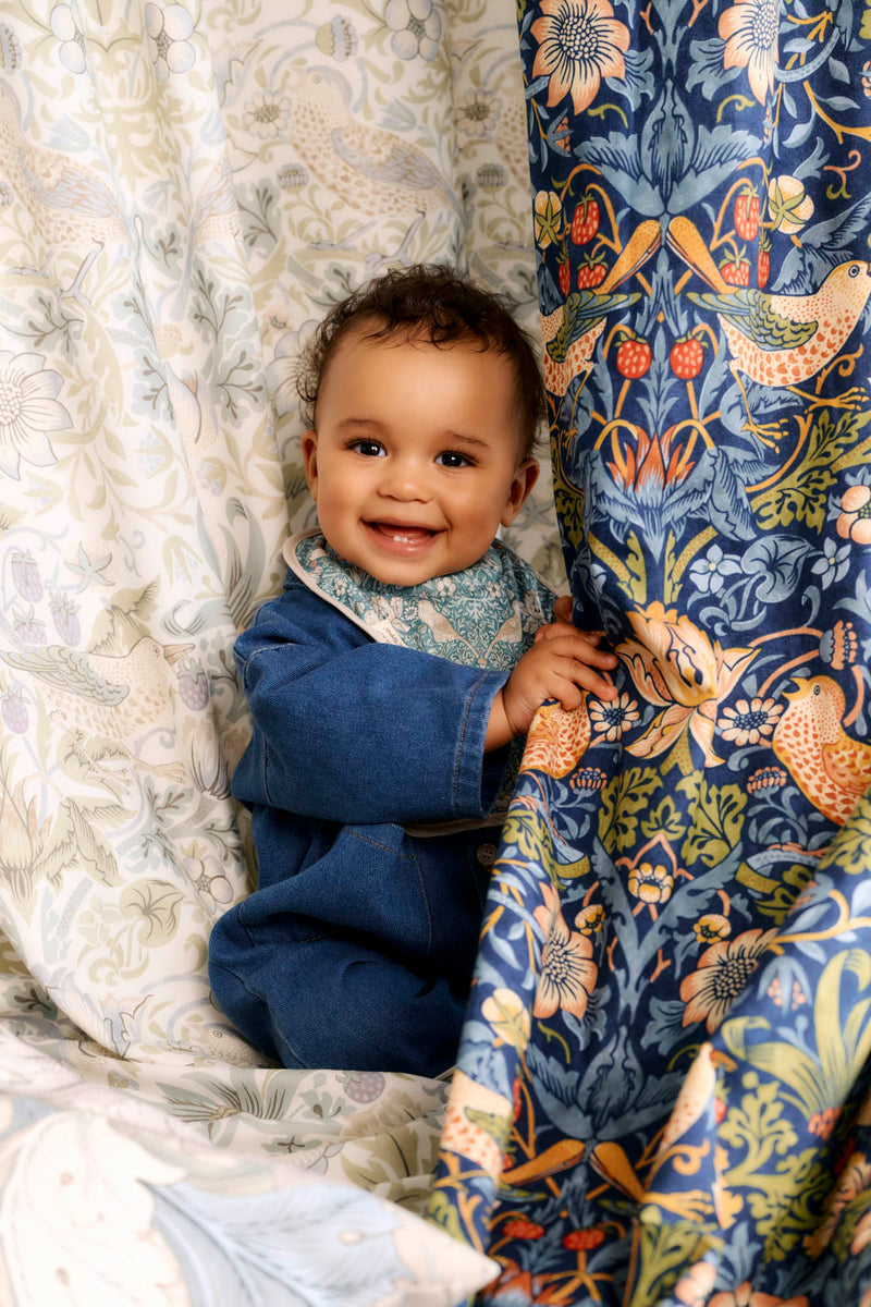 baby smiling behind fabric