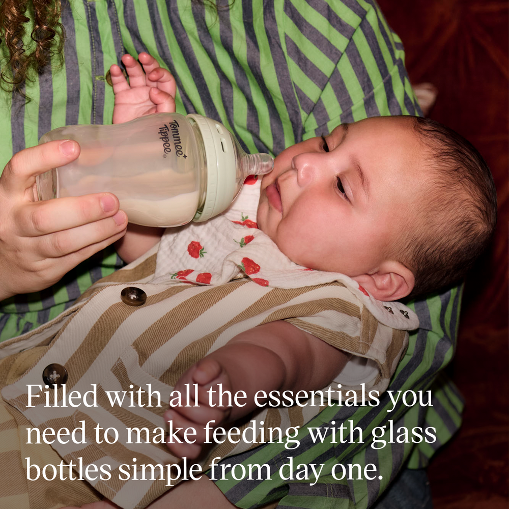 Woman feeding her baby using a Tommee Tippee glass Natural Start bottle with text overlay stating “Filled with all the essentials you need to make feeding with glass bottles simple from day one.”