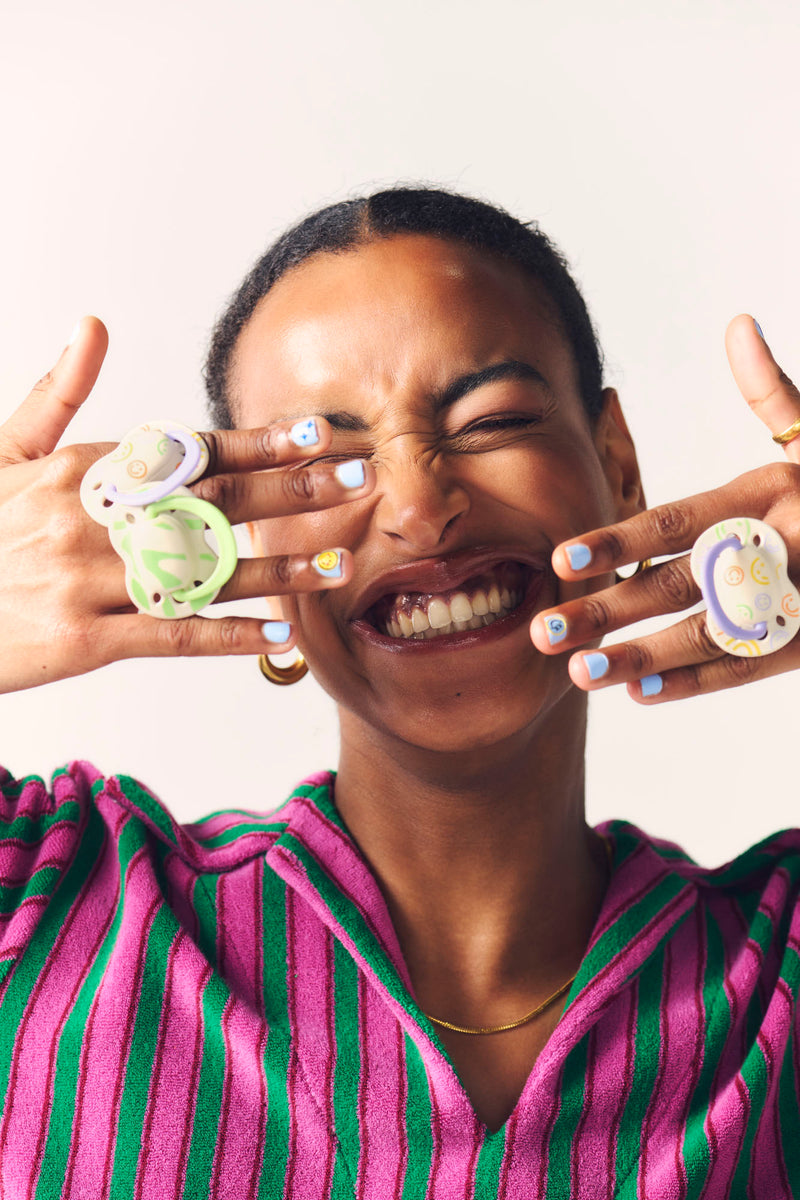 mum with soothers on fingers smiling
