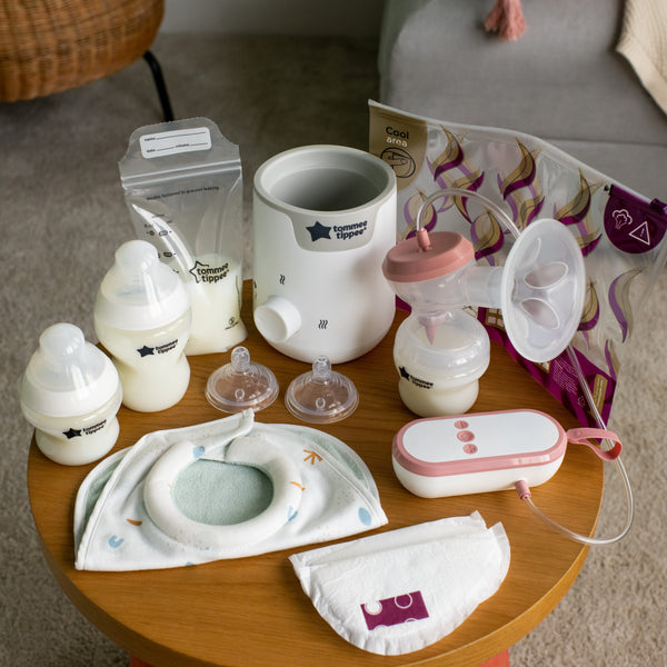 All Complete Breastfeeding Kit components placed on a bedside table
