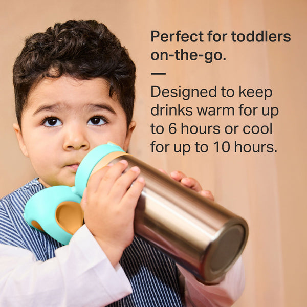Toddler drinking from a Tommee Tippee On-the-Go Stainless Steel Insulated Bottle with text stating 