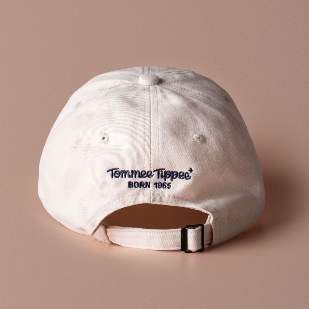 The back of the Never off duty white cap on brown background