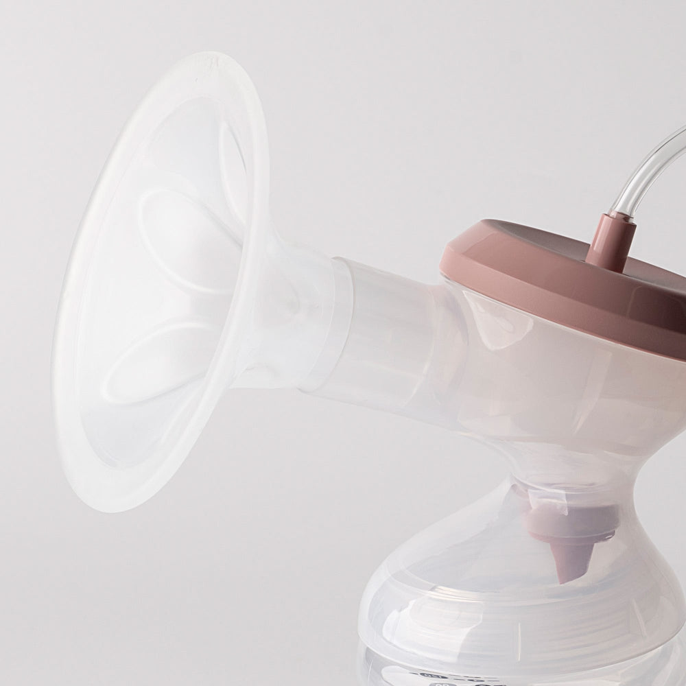 Side shot of an electric breast pump showing the hood.