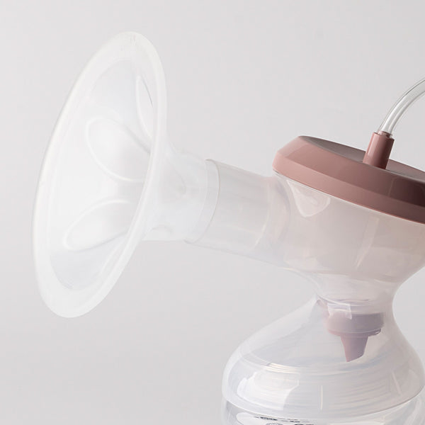 Side shot of an electric breast pump showing the hood.