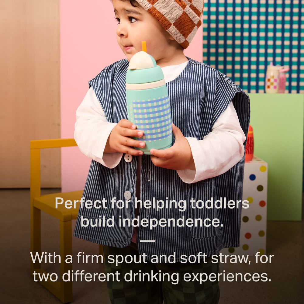 Toddler holding a Tommee Tippee Insulated Active Straw Cup with text stating 