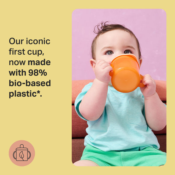 Image of a toddler sat on the floor drinking from an orange first cup with text overlay of product USP