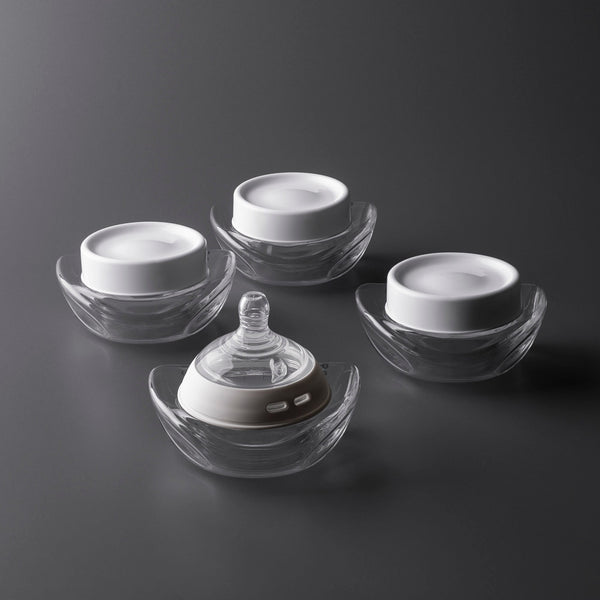 Three collector bottles with lids and one collector bottle with nipple attached.