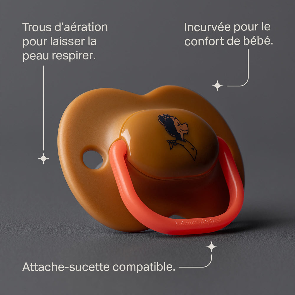 Apaisant bronzant sur fond gris avec des pointeurs vers les principales caractéristiques du produit