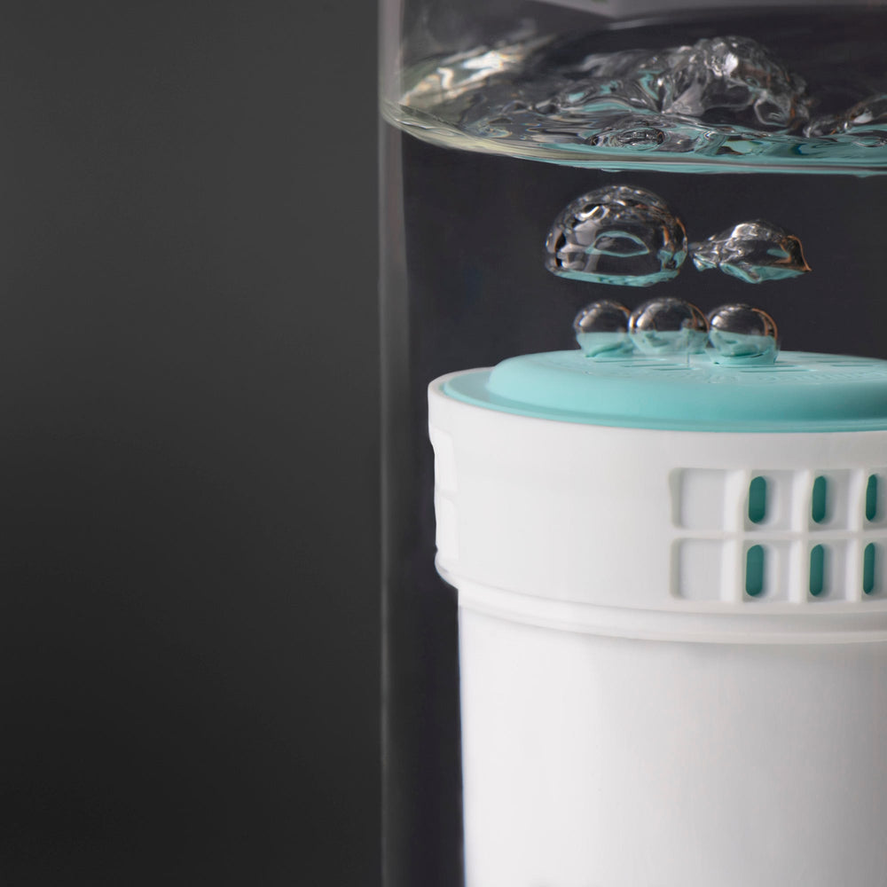 Close up image of a Perfect Prep filter submerged in water with bubbles coming from it