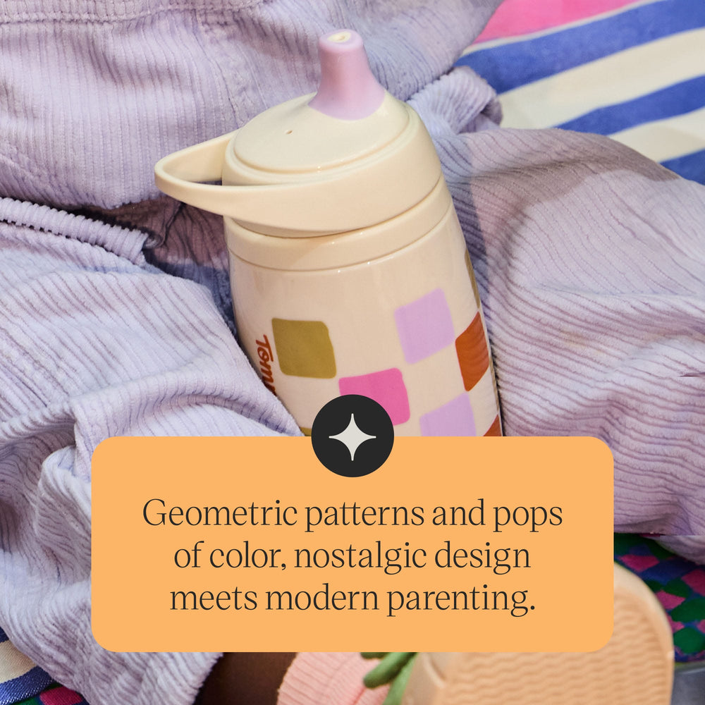Toddler sitting down with a Tommee Tippee Insulated Active Spout Cup in their lap with text stating 
