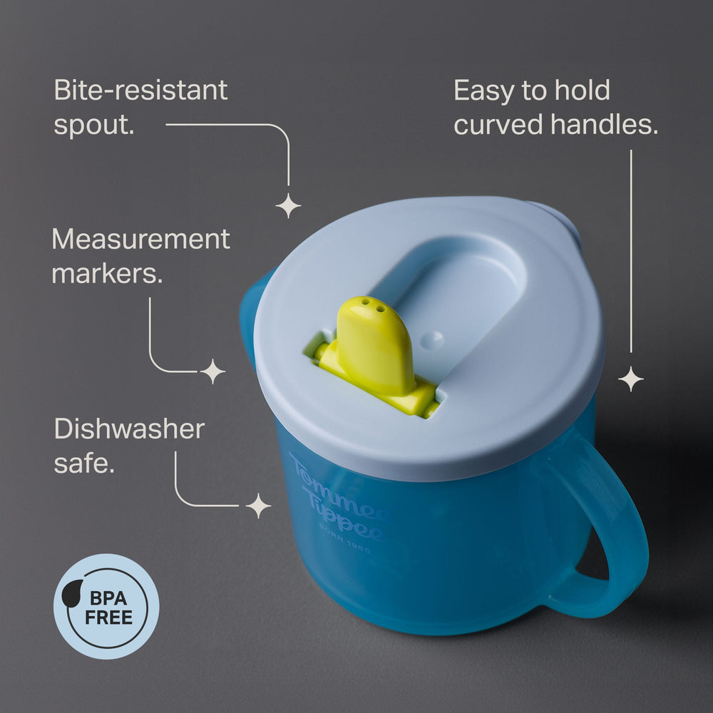 Tommee Tippee First Cup against a grey background with pointers stating 