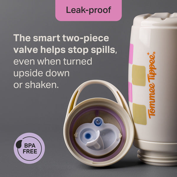Tommee Tippee Insulated Active Spout Cup against a grey background with the lid removed to show the two-piece valve inside with text stating 
