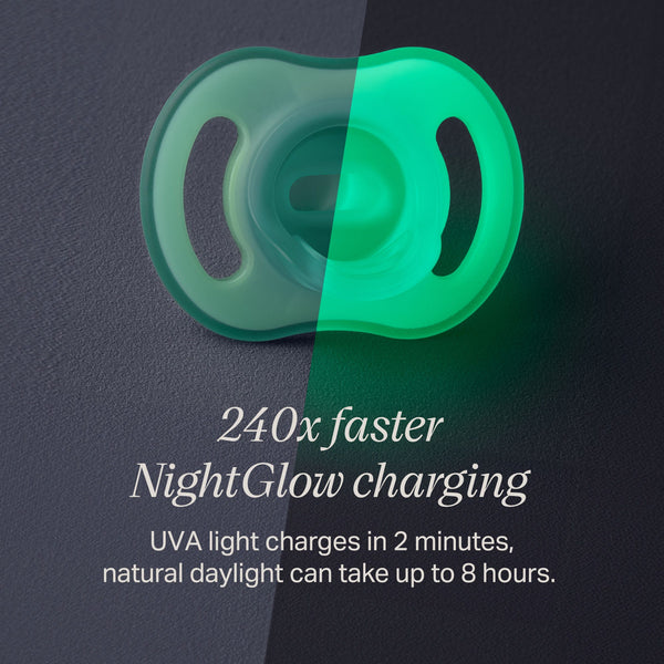 Ultra-light NightGlow pacifier in two halves to show charge with the NightGlow Pod versus daylight.