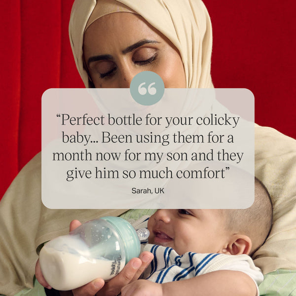 Baby drinking from an Advanced Anti-colic bottle with text overlay of customer review