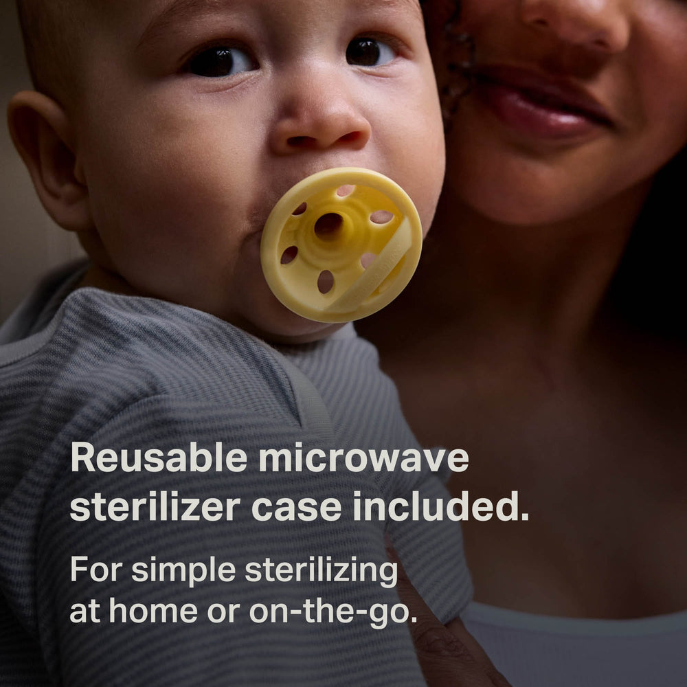 Baby with a paci on parent's lap and information about the reusable sterilizer pod.