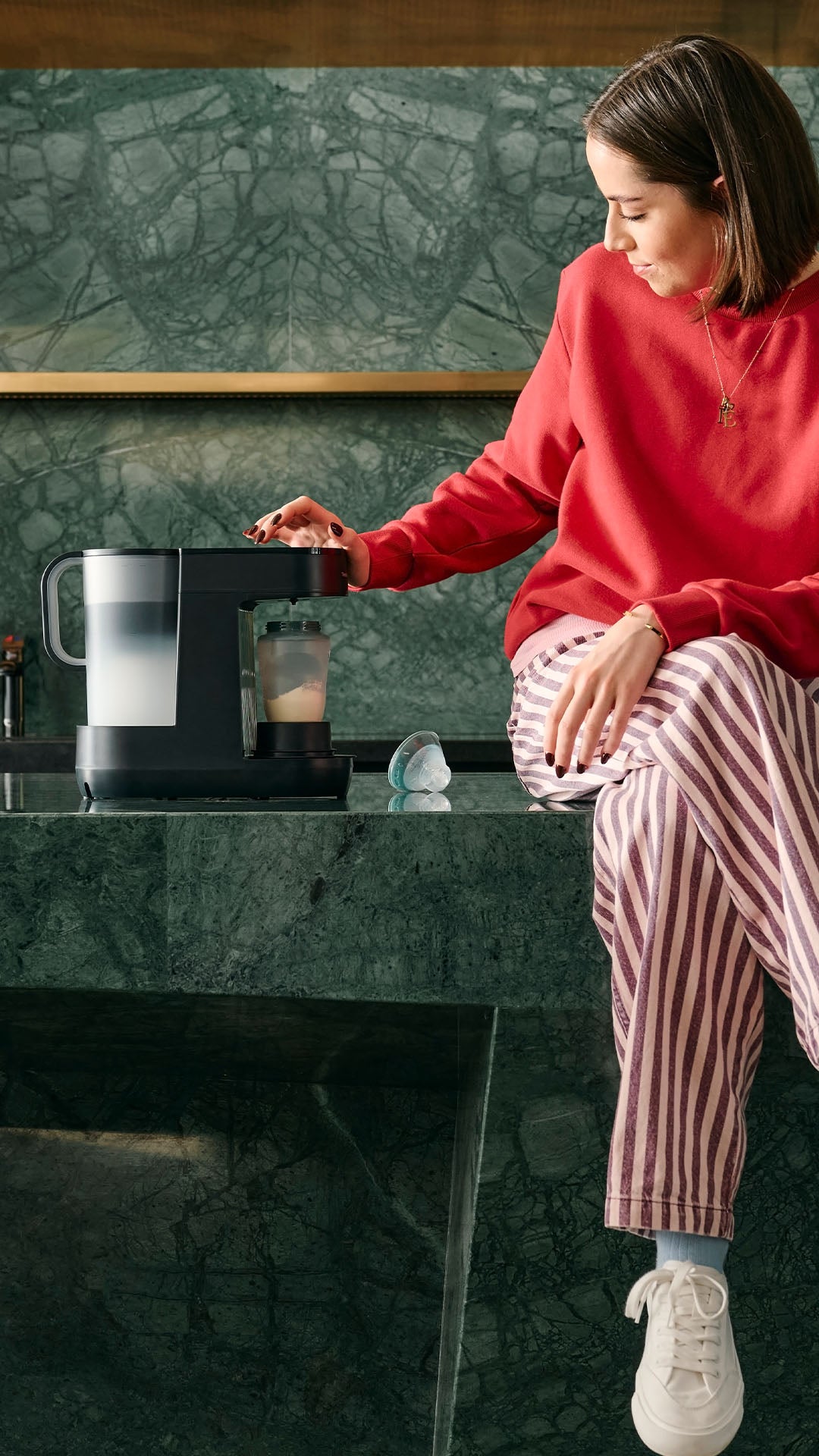 Mum sat on kitchen bench using Perfect Prep®