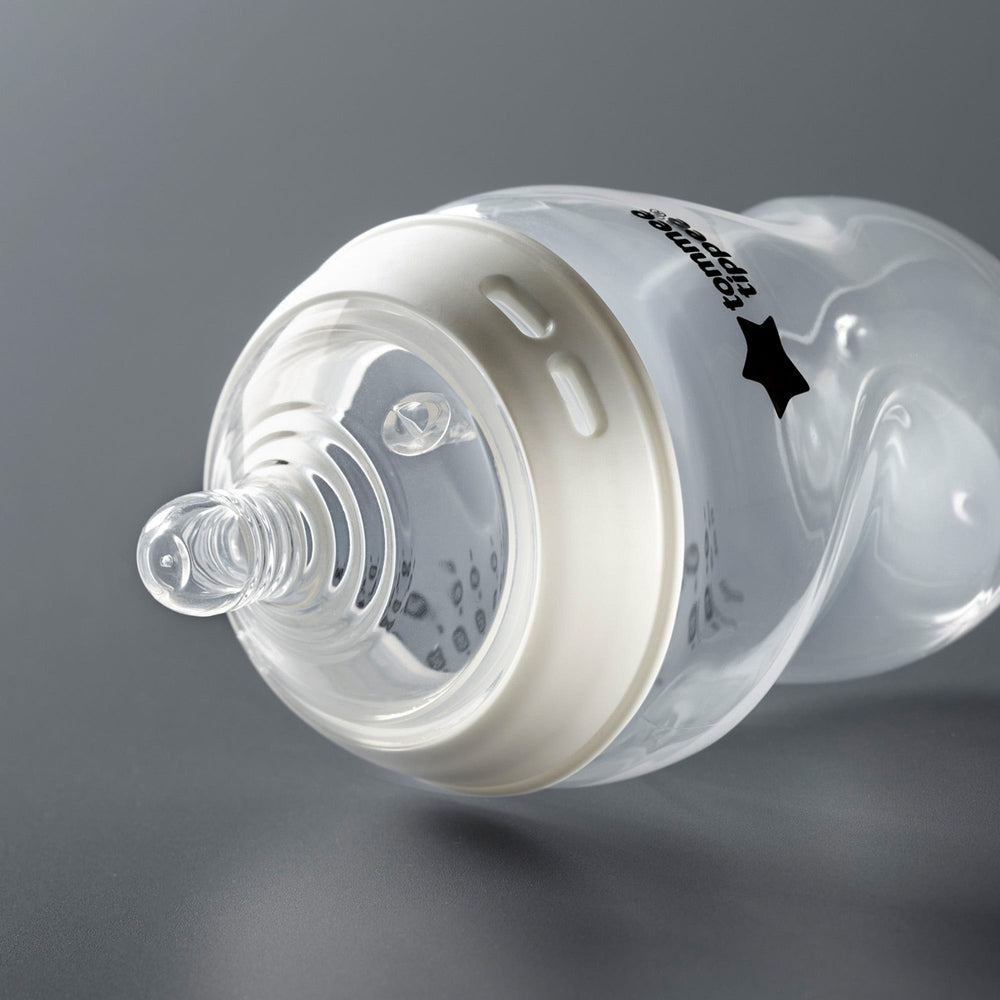 Natural Start bottle laying on its side on a dark grey background.