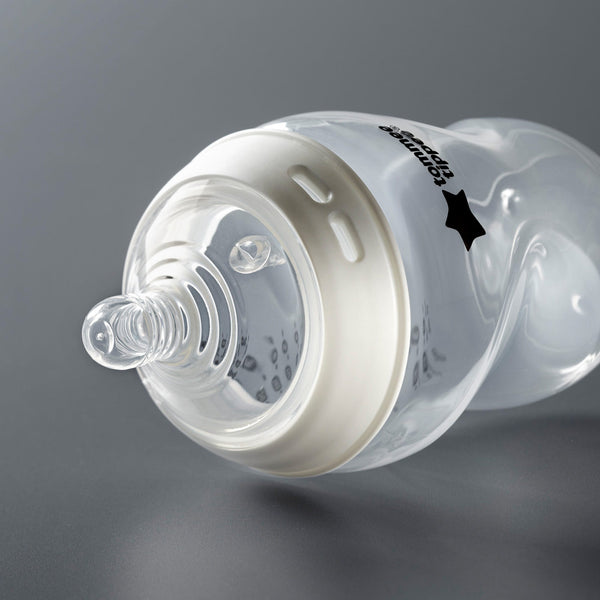 Natural Start bottle laying on its side on a dark grey background.
