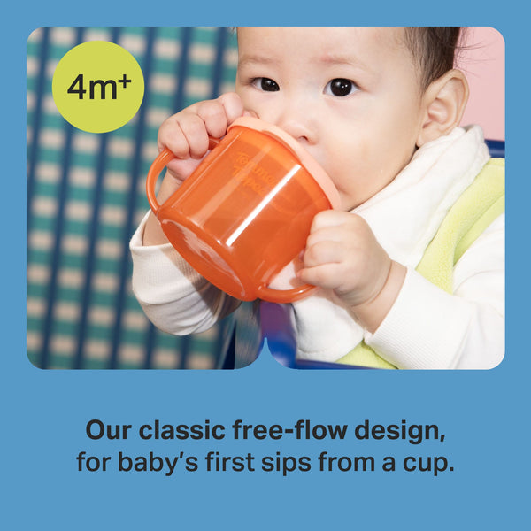 Toddler drinking from a Tommee Tippee First Cup with text stating 