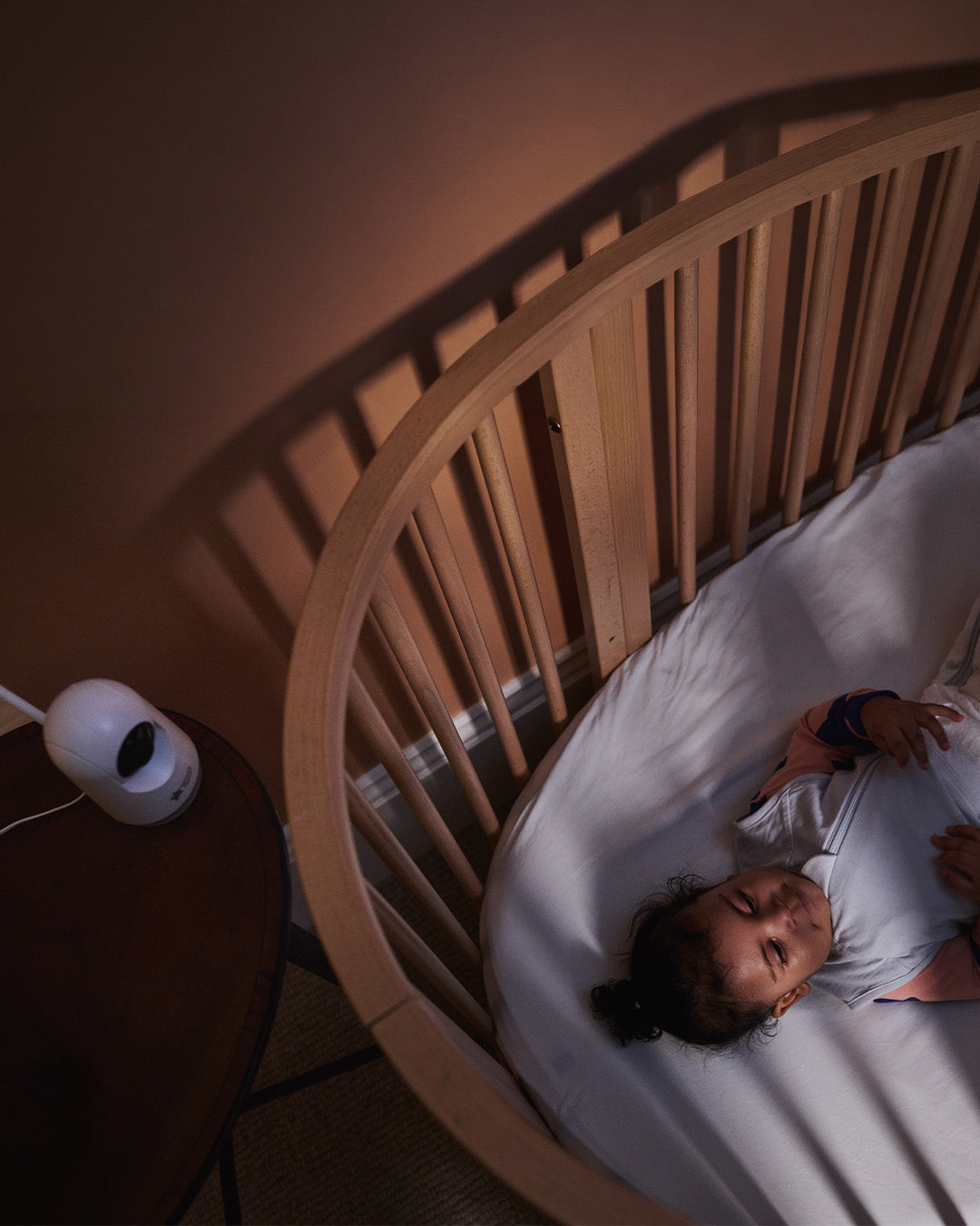 Toddler in cot with Dreamview watching from above