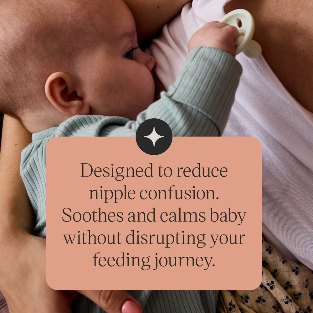 Upward-facing pacifier with text about the symmetrical shield and nipple.