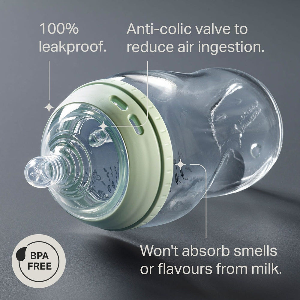 Natural Start glass bottle laying on its side against a grey background with pointers to the key product features