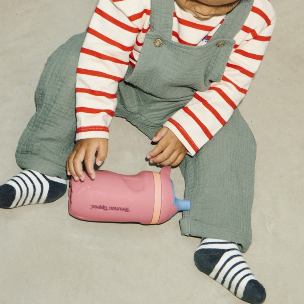 Image of a toddler sat on the floor playing with an Insulated Sporty Spout and Straw Cup