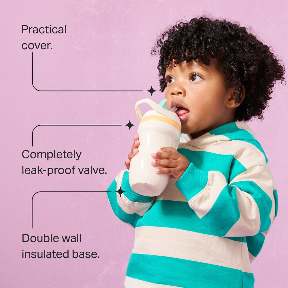 Toddler drinking from an insulated sporty straw cup against a pink background with pointers to the product key features