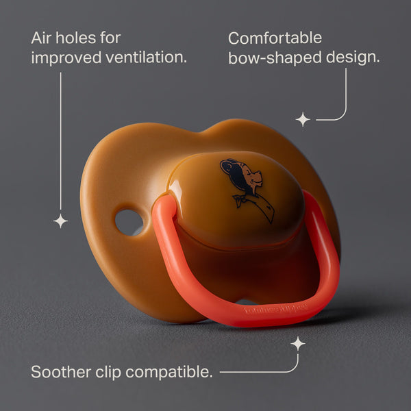 Tan soother against a grey background with pointers to the product key features