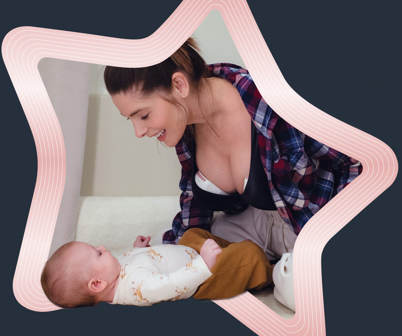 Mum using wearable breast pump with baby lying