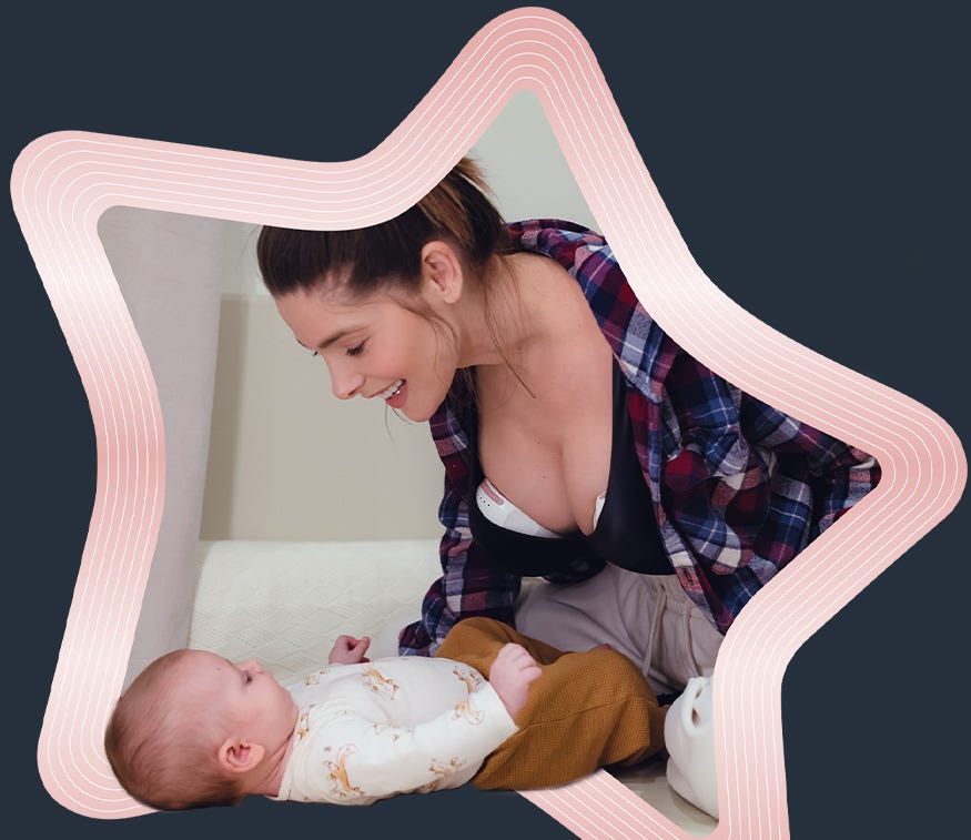 Mum using wearable breast pump with baby lying
