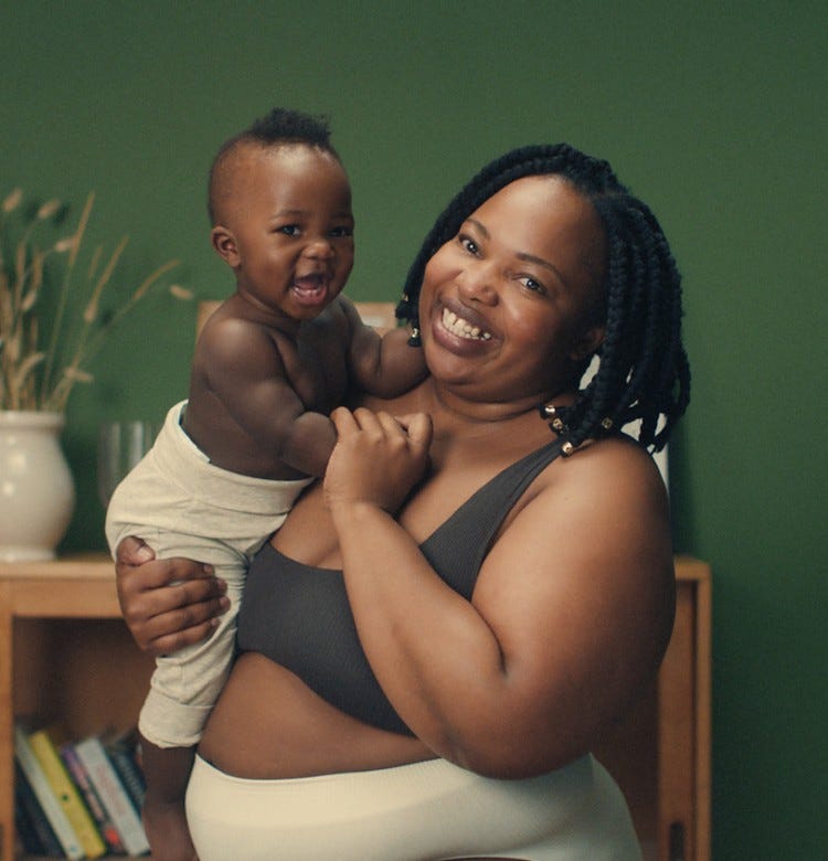 What Are the Benefits of Breastfeeding? smiling mum holding her baby