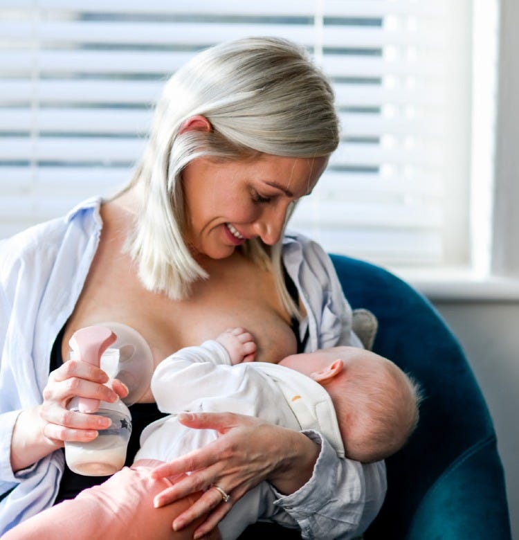 How to Clear a Blocked Milk Duct Mum breastfeeding her baby while using a hand-held manual breast pump
