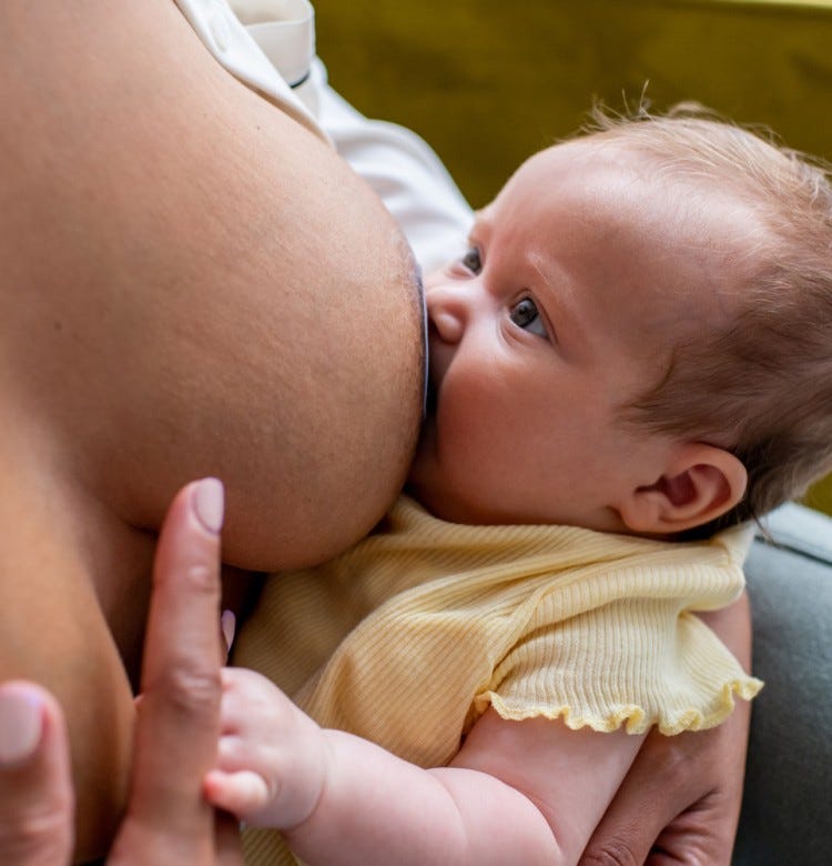The Initial Hours of Breastfeeding: What to Expect baby breastfeeding using a nipple shield