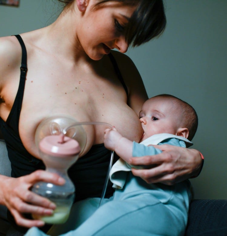 Breastfeeding: Ways To Increase Breast Milk Supply mum using a breast pump while breastfeeding her baby