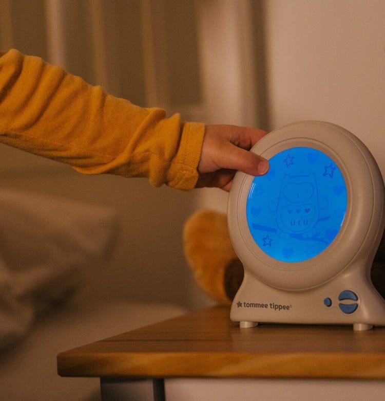 Coping with Bedtime When the Clocks Change toddler pointing at their tommee tippee groclock