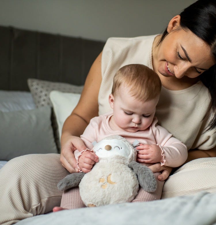 What is Co-Sleeping? baby and mum playing with ollie owl sleep aid