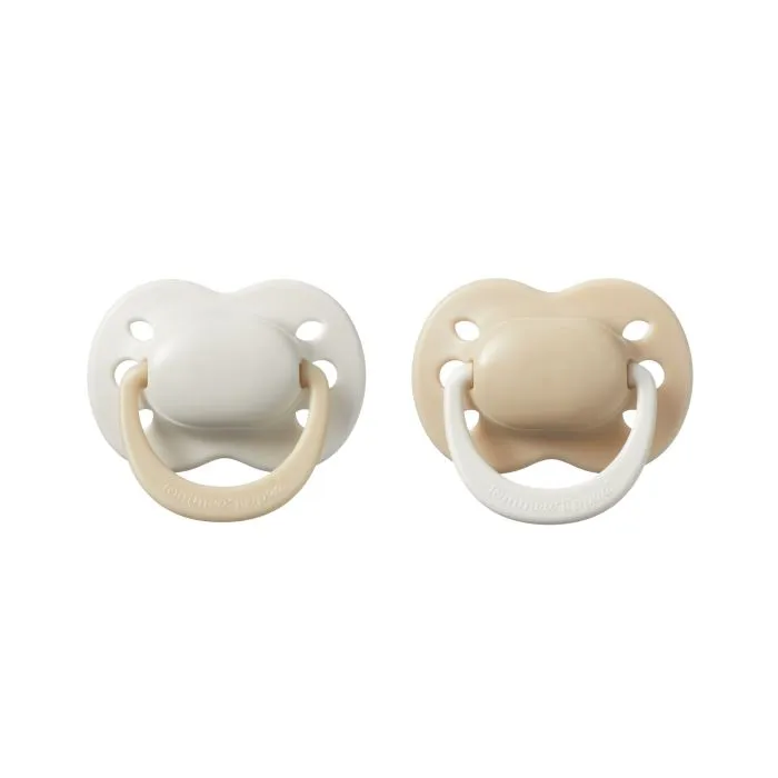 Newborn pacifiers on a white background.