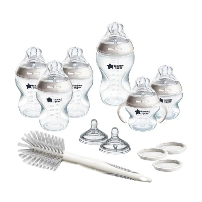 All Grow with Baby bottle set components against a white background