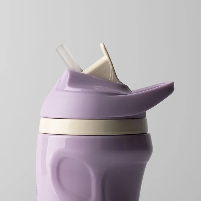 Close up of purple insulated sporty straw cup against a light grey background