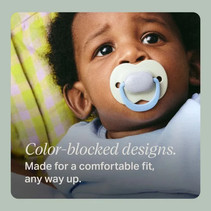 Baby with a 6+ months' Ultimate Fit paci with text about the color blocked design.