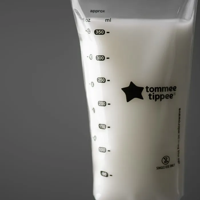 Filled breast milk storage bag on a charcoal background.