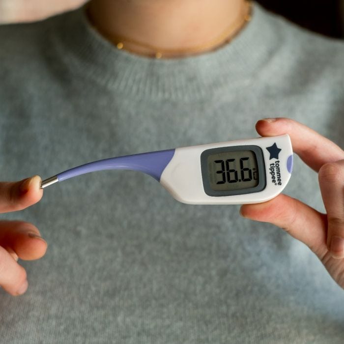 Flexipen thermometer being held and the tip is being pushed down to show how flexible it is.