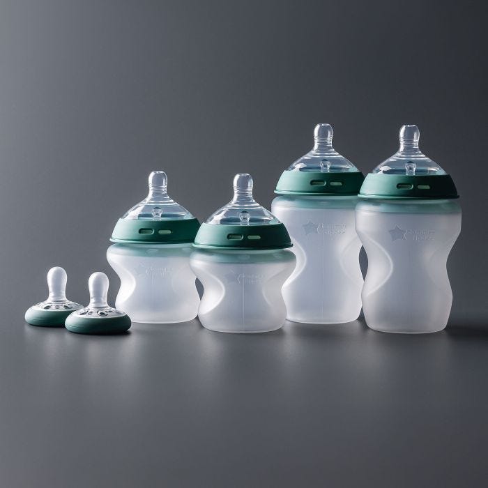 Wide shot of 5oz and 9oz silicone bottles and two breast-like pacifiers included in the set.